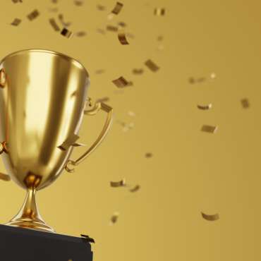 Golden winner cup and confetti