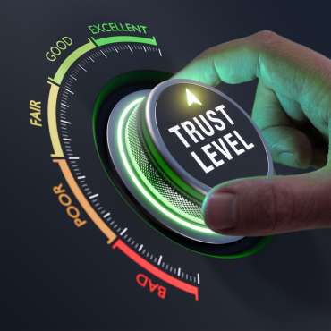 Build trust in business and finance relationships. Trusted partner. Trustworthy collaboration, company or contract. Confidence to work together. Businessman turning knob to highest trust levels.