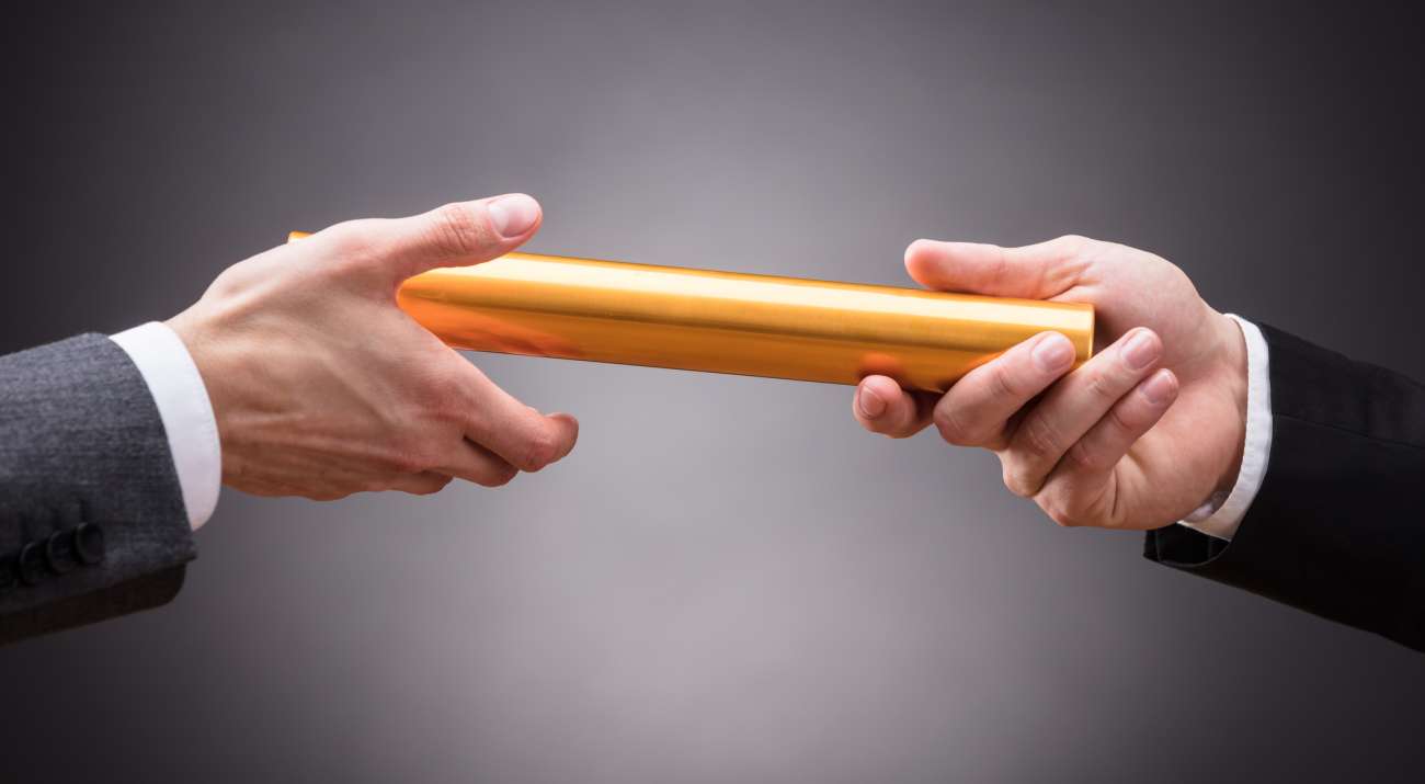 Person Passing Baton To Businessperson
